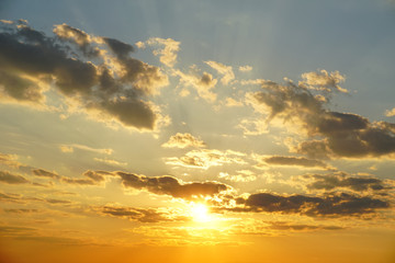 sunset sky with clouds and sunny beams