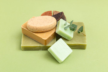 Natural  soap and  eucalyptus on a green background. Selective focus. Muted shades. Selective focus