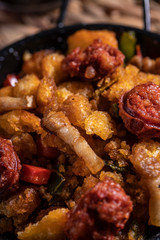 Extremadura crumbs, typical plate of Extremadura, breadcrumbs, bacon, red and green pepper, garlic and paprika, with a glass of red wine