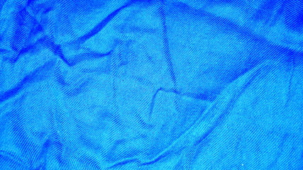 Blue background with space for text. Crumpled blue fabric.
