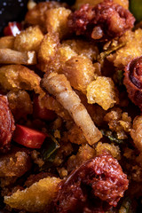 Extremadura crumbs, typical plate of Extremadura, breadcrumbs, bacon, red and green pepper, garlic and paprika, with a glass of red wine