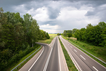 Highway road in the countryside surrounded by lush green