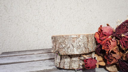 Dried rose and timber on a white background