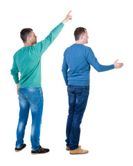 Obraz premium Back view of two man in sweater pointing.