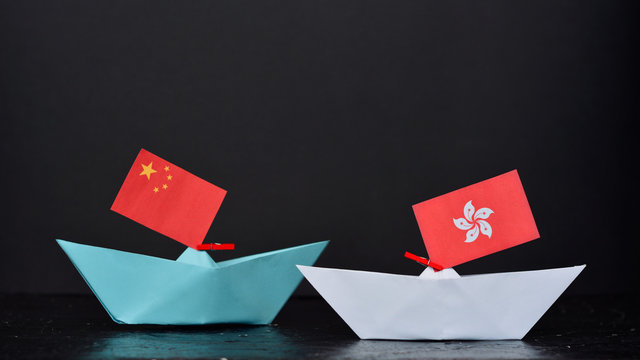 Paper Ship With National Flag Of China And Hong Kong, Concept Of Conflict, Shipment Or Free Trade Agreement 