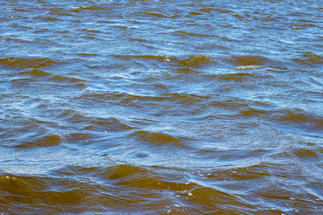 Turbulent river before the storm. Waves on the dark water of the river