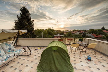 Enjoy adventure at home and staying in tent on the terrace. Enjoying sunrise from home during covid-19 pandemic © danmir12