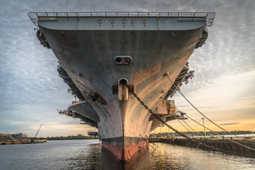 Close-up from the front of aircraft carrier USS John F. Kennedy in the NAVSEA Inactive Ships Maintenance facility at the Philadelphia navy yard. - obrazy, fototapety, plakaty