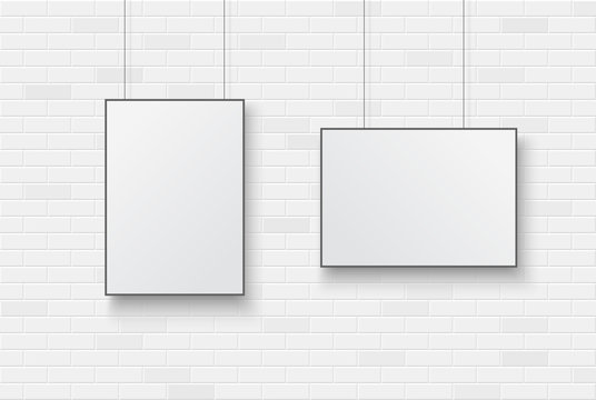 Blank poster on a white brick wall.