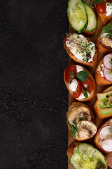Italian bruschetta with tomatoes, mushrooms, mozzarella cheese and herbs on a cutting Board 