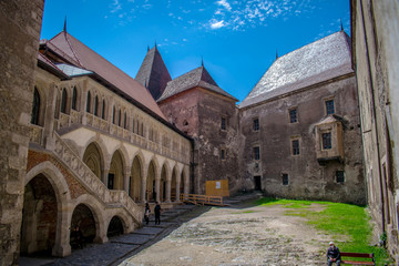 The inner courtyard of a castle in Romania. Corvin Castle, also known as Hunyadi Castle. Hunedoara,...