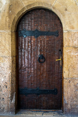 Old wooden door at the entrance to a medieval castle in Romania