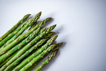 Extreme close-up image of fresh asparagus on white background. Vegetables: Asparagus Isolated on White Background. Fresh ripe asparagus on a white background