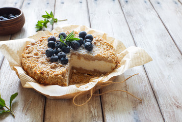 Grated rustic pie with ricotta on natural wooden background