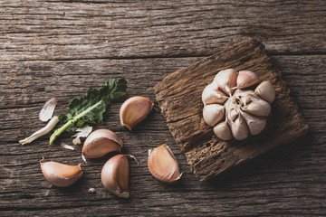 garlic and garlic powder on old wood, close up image