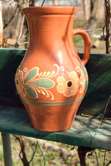 rustic clay jug with flowers