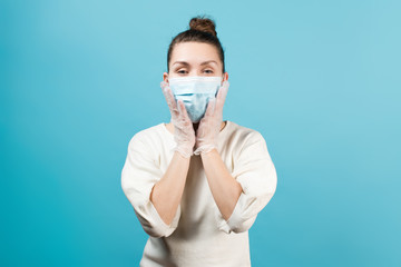 woman in protective medical mask touches her face in protective medical gloves.