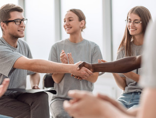 handshake of young people in a circle of like-minded people.