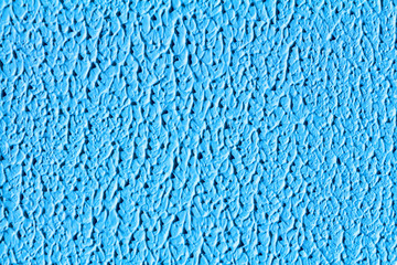 Texture of modern blue color of artistic plaster. The concept of abstraction of waves, mountains with shadows, the surface of the planet.