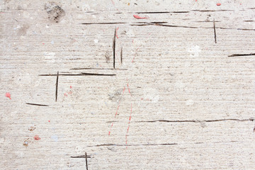 The texture of a rough, rough concrete floor with straight slits from the grinder.