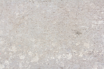 The texture of a rough, cracked concrete floor.