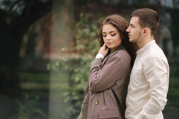 Portrait of couple in love. Young man and woman with curly hair outdoors