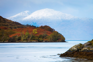Autumn landscape in Highlands, Scotland, United Kingdom. Beautiful mountains with snow in background.