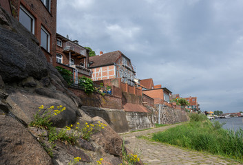 Fototapeta na wymiar Old town of Lauenburg, coastal promenade and historic brick houses on the dike wall made of field stones on the river Elbe in northern Germany, Europe, copy space