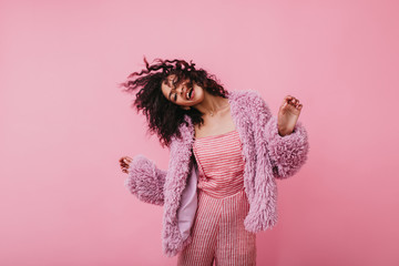 Incendiary fantastically beautiful girl in coat of eco fur moves fun. Picture of lovely lady in...