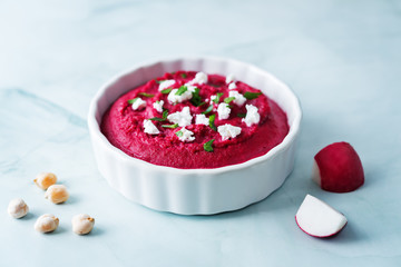 Beet hummus appetizer with carrot, radish, tomato and cucumber
