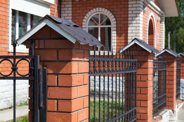 brick fence with a house