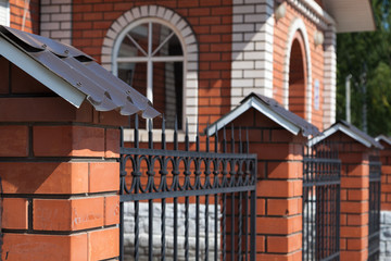 brick fence with a house