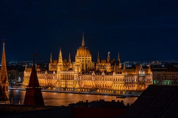 Fototapeta na wymiar Danube river side view of Hungarian Parliament in the night from pest hill
