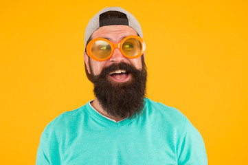 Good vision. Fun and entertainment. Funny accessory. Man eyewear model. Funny sunglasses. Bearded man in sunglasses orange background. Hipster wear party sunglasses. Eyes health. Eyesight check ups