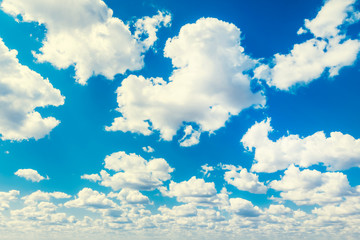 Blue pure sky with many white large clouds. Settled clear weather. Heavenly background, excellent wallpaper. Distance view. Fluffy cumulus clouds. Wide angle. Ozone layer. High cloudiness and forecast - obrazy, fototapety, plakaty