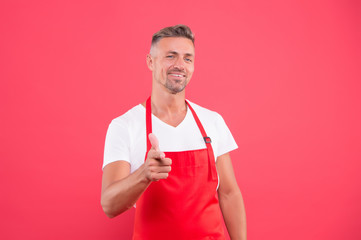 happy entrepreneur of coffee shop. Male barista wear uniform. unshaven man work as barista. Part-time job. confident barista man pointing finger. mature skilled barista wear red apron