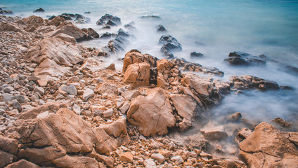 Rocks and waves at a pebble beach near Novalja town on Pag island in Croatia