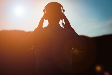 Fototapeta stylish bearded man in headphones listening to music obraz