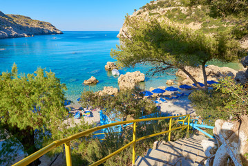 Naklejka premium Stairs to Anthony Quinn Bay, secluded beach on the island of Rhodes. Greece