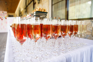 on a wooden table in the wedding banquet area are snacks, fruits, sweet cakes and muffins and lemonade drink