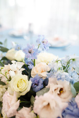 banquet table is decorated with plates, cutlery, glasses, candles and flower arrangements