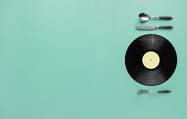 Music taste or retro cafe creative minimal concept  with vinyl record as plate and knife and fork...