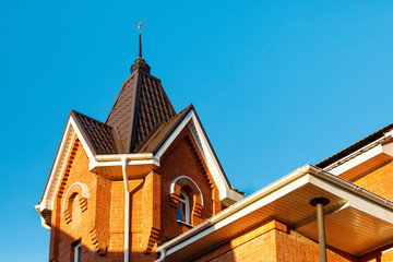 Small tower on the roof. New roof structure on the decorative tower of a brick cottage with Dormer...