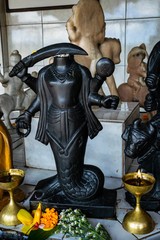  Headless statue holding knife in Hindu temple at sacred Lake of Ganga (Ganga Talao). Mauritius,...