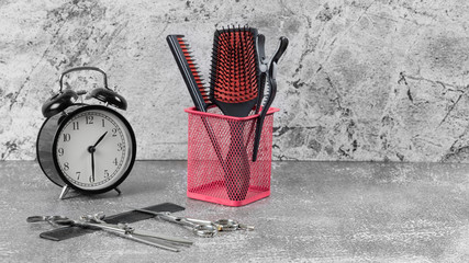 Hairdressing set in pink form on a gray background