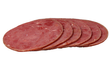 Sliced sausage slices lie on a white background. Isolated.