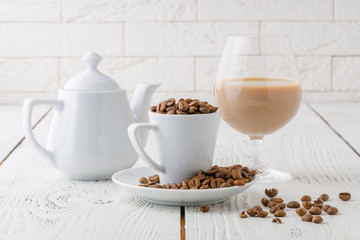 coffee beans from the white ceramic cup
