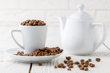 coffee beans from the white ceramic cup
