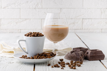 coffee beans from the white ceramic cup