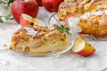 Apple pie Classic american dessert. Homemade baking on a wooden background. Red apples near the pie